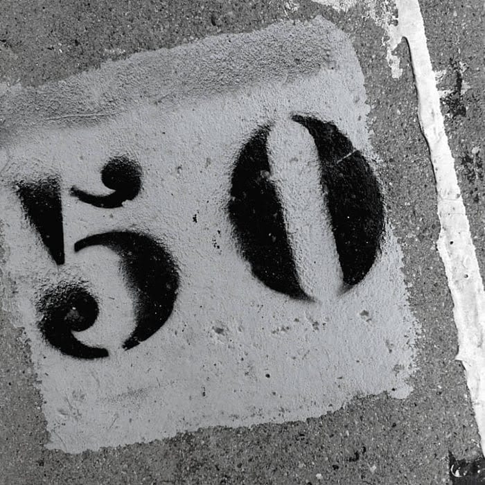 black and white paint on a sidewalk with the number 50